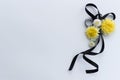 Decoration from black funeral ribbon with yellow flowers.