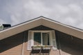 The roof and facade of a wooden country house. Royalty Free Stock Photo