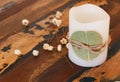 Decoration candle with dried leaf ando flowers on wooden table