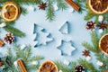 Decoration for Christmas concept. Food oranges nuts spices pine cones Christmas tree on blue pastel background with copy space. Royalty Free Stock Photo