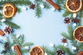 Decoration for Christmas concept. Food oranges nuts spices pine cones Christmas tree on blue pastel background with copy space. Royalty Free Stock Photo