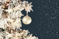 Decoration on Christmas tree - white birds and silver ball on snowy spruce on dark blue background with snow mist Royalty Free Stock Photo