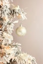 Decoration on Christmas tree - white birds and silver ball on snowy spruce on light gray background. Closeup Royalty Free Stock Photo