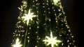 Decoration of a city festive christmas tree. Concept. Bottom view of a green New Year spruce tree illuminated by the Royalty Free Stock Photo