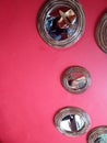 Decoration and design of red wall with mirrors and reflection of woman with hat