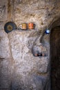 decoration in the doorway of a doorway of a house carved in rock in cappadocia, turkey, some cups, a plate and a tea set with a Royalty Free Stock Photo