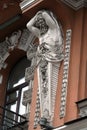 Decoration of the facade of the building with sculptures and busts of Atlantes