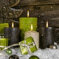 Decoration: four green and brown burning advent candles for christmas with presents. Royalty Free Stock Photo