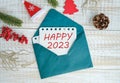 Decoration with four leaf clover and board for New Year 2023 with text in english HAPPY 2023