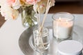 Aroma reed diffuser, candle and flowers on table Royalty Free Stock Photo