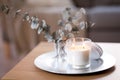 Burning fragrance candle on table at cozy home