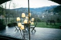 Decoration lamp with many bulbs reflecting on a window glass terrace on a winter mountain empty mountain landscape