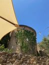 Decoration Light bulbs tied in a rope on a medieval rocks tower townscape under a blue sunny Sumer sky in Girona, Catalonia