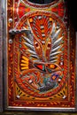 Colorful eagle with fish in claws on a door of pakistani truck