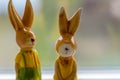 Decoration rabbits stands near a window