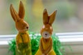 Decoration rabbits stands near a window