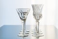 Decoration setup of wine and martini glasses set up in rows on a reflective table top