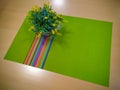 Decoration on the table consisting of green dining tablecloth and fake yellow flowers in a pot