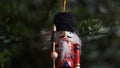 Decoration Toy Nutcracker On Christmas Tree. Nutcracker Soldier On A Christmas Tree With Blurred Background.