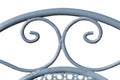 Decoration of the upper part of a metal chair.. Metal cylinders making curves. Bluish-gray color