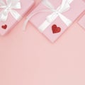 Decoration valentine`s day on table top view background. Flat lay composition of heart and pink gift box coral paper background