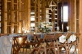 Decoration wedding table before a banquet in a wooden barn. Royalty Free Stock Photo