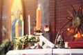 Decoration on the wedding table with candle, Rose vase,book, pen in Christian marriage. Wedding ceremony in christian church Royalty Free Stock Photo