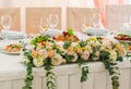 Decorations of the banquet table with a large bunch of white roses. Royalty Free Stock Photo