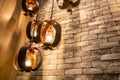 Decorative antique edison style filament light bulbs on brick wall background. Royalty Free Stock Photo