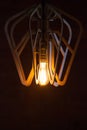 Decorative antique Edison style light bulb against a brown Royalty Free Stock Photo