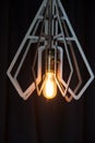 Decorative antique Edison style light bulb against a brown wall Royalty Free Stock Photo