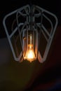 Decorative antique Edison style light bulb against a brown wall Royalty Free Stock Photo