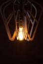 Decorative antique Edison style light bulb against a brown wall Royalty Free Stock Photo