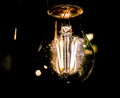 Decorative antique edison style light bulb on black background