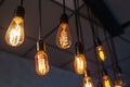 Decorative antique edison style light bulbs against brick wall background Royalty Free Stock Photo