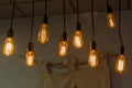 Decorative antique edison style light bulbs against brick wall background Royalty Free Stock Photo