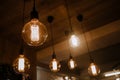 Decorative antique edison style light bulbs against brick wall background Royalty Free Stock Photo