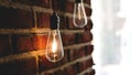 Decorative antique edison style light tungsten bulbs against brick wall Royalty Free Stock Photo