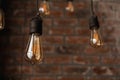 Decorative antique edison style light tungsten bulbs against brick wall Royalty Free Stock Photo