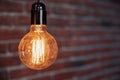 Decorative antique edison style light tungsten bulbs against brick wall background Royalty Free Stock Photo