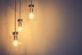 Decorative antique light bulbs against concrete wall background.