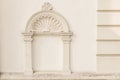 Decorative arch and semi vault above niche with classic pillars. Architectural stucco detail of old European buildingin Royalty Free Stock Photo