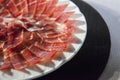 Decorative arrangement of iberian cured ham on plate Royalty Free Stock Photo