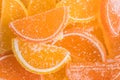 Decorative Background of yellow and orange marmalade candy in shape of citrus fruits wedges. Jelly sweet candies. Food Texture. Royalty Free Stock Photo