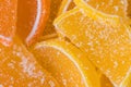 Decorative Background of yellow and orange marmalade candy in shape of citrus fruits wedges. Jelly sweet candies. Food Texture. Royalty Free Stock Photo