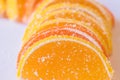 Decorative Background of yellow and orange marmalade candy in the shape of citrus fruits wedges. Jelly sweet candies. Food Texture Royalty Free Stock Photo