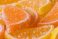 Decorative Background of yellow and orange marmalade candy in shape of citrus fruits wedges. Jelly sweet candies. Food Texture. Royalty Free Stock Photo