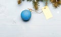 Decorative ball toy and gift tag copy space. Get ready for christmas. Christmas decorations wooden background top view Royalty Free Stock Photo