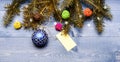 Decorative ball toy and gift tag copy space. Get ready for christmas. Christmas decorations wooden background top view Royalty Free Stock Photo