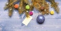 Decorative ball toy and gift tag copy space. Get ready for christmas. Christmas decorations wooden background top view Royalty Free Stock Photo